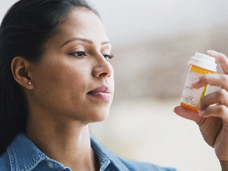 Hispanic woman reading medication